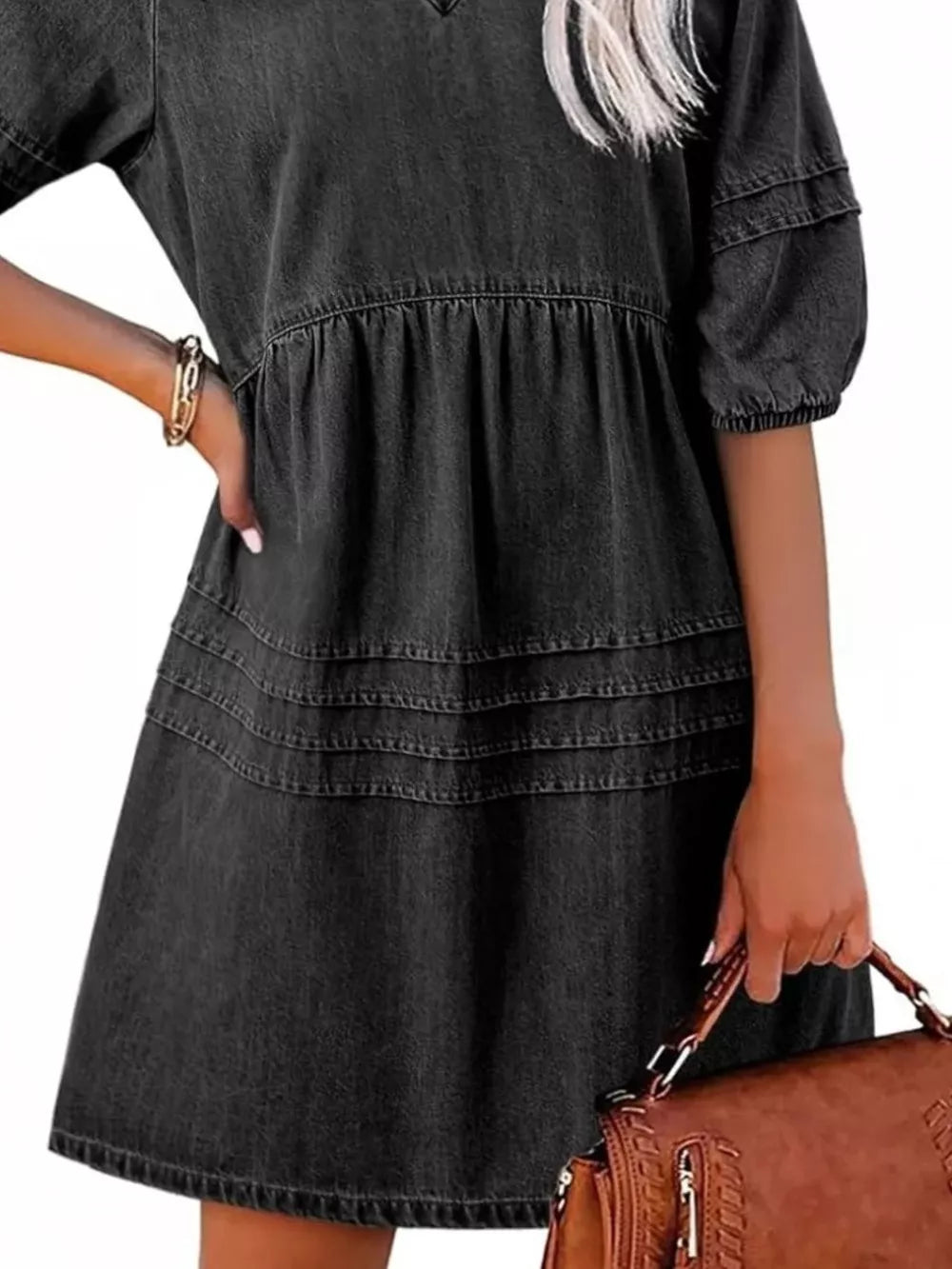 Black denim mini dress with puff sleeves, tiered skirt, and smocked waist.