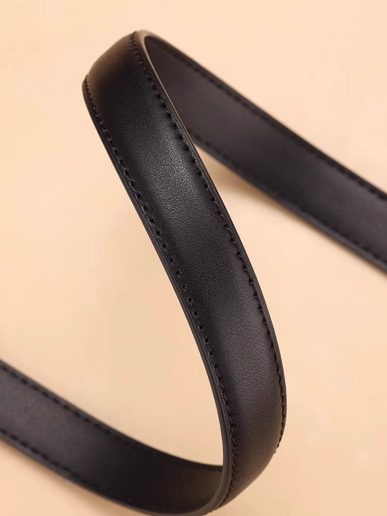 Black cowhide leather belt with silver buckle detail and stitching