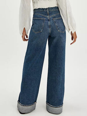 Cuffed wide-leg denim trousers in dark blue with a relaxed fit and visible back pockets.