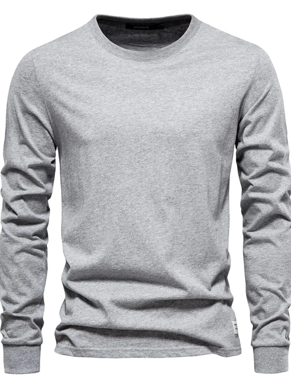 Gray crewneck long sleeve t-shirt with a relaxed fit and a small white tag detail on the hem.