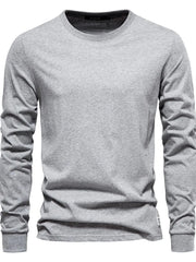 Gray crewneck long sleeve t-shirt with a relaxed fit and a small white tag detail on the hem.
