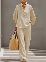 Chic buttoned loungewear set in apricot, featuring a stand collar, half sleeves, and wide-leg pants.