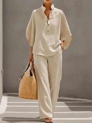 Chic buttoned loungewear set in apricot, featuring a stand collar, half sleeves, and wide-leg pants.