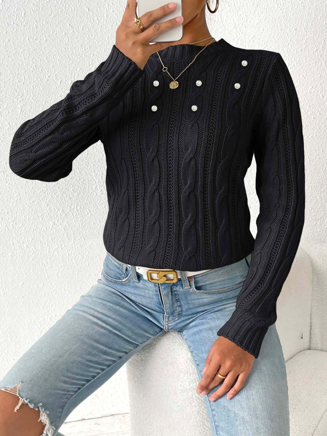 Black cable knit sweater with pearl embellishments and a mock neck.