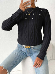 Black cable knit sweater with pearl embellishments and a mock neck.
