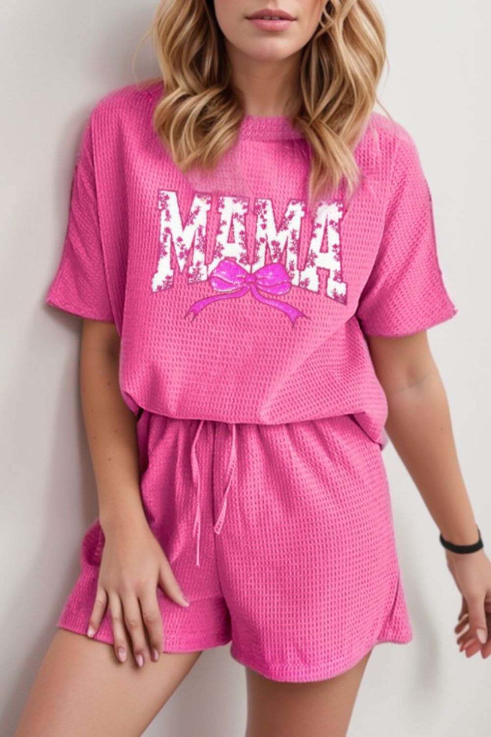 Fuchsia pink waffle knit lounge set with "Mama" graphic and bow detail.