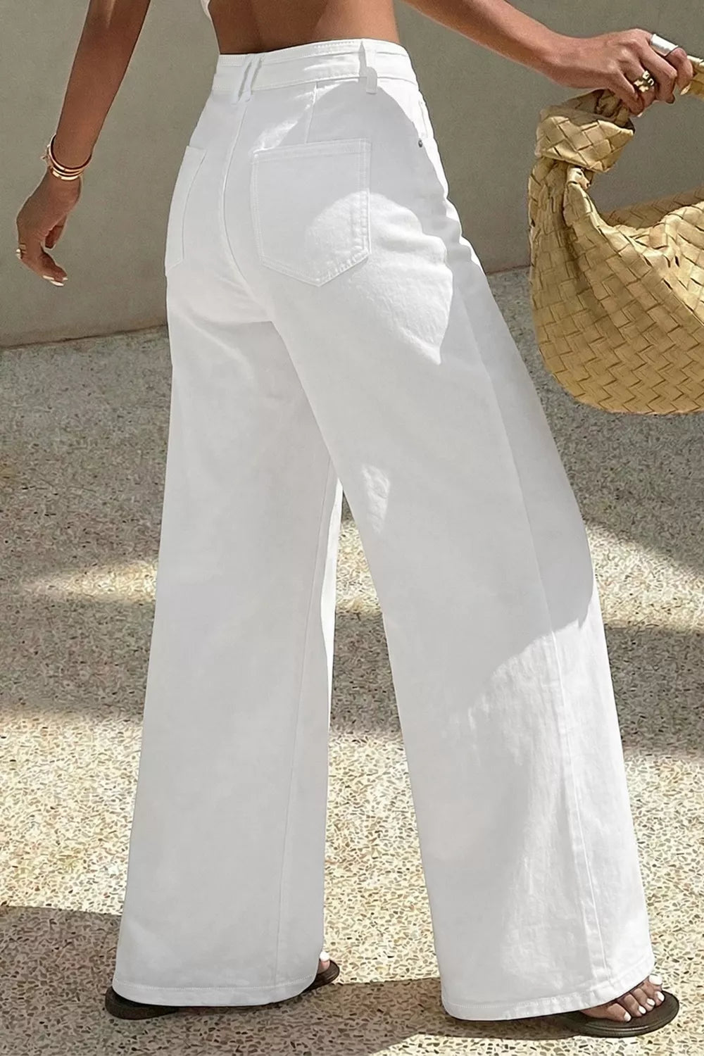 White denim casual wide-leg high-waisted jeans with button fly and back pockets.