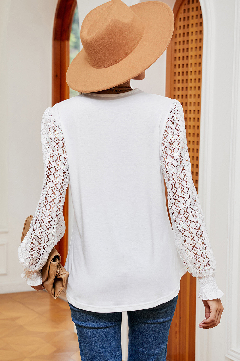 White knit top with full lace sleeves and smocked cuffs.
