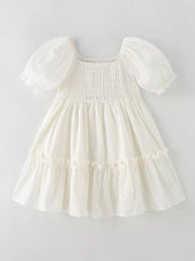 Cream cotton blend toddler dress with puff sleeves, square neckline, smocked bodice, and tiered ruffle skirt.
