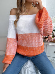 Off-shoulder colorblock knit sweater with balloon sleeves in white and orange acrylic.