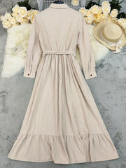 Belted maxi dress in khaki with ruffled hem and button front.