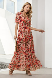 Tiered floral maxi dress in peach with puff sleeves and ruffled neckline.