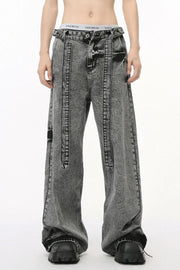 Acid wash belted palazzo jeans in dark wash with a relaxed fit and wide leg.