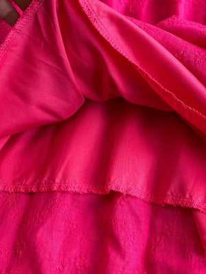 Pink lace-embellished A-line midi dress with textured floral detail.