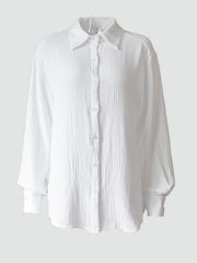 Textured cotton overshirt in white with relaxed fit and button front.