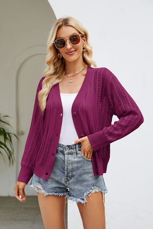Cerise openwork knit button-down cardigan with V-neck and long sleeves.