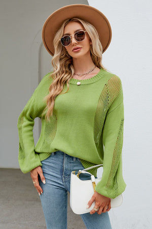 Green knit sweater with slit detail, crew neck, and long sleeves.
