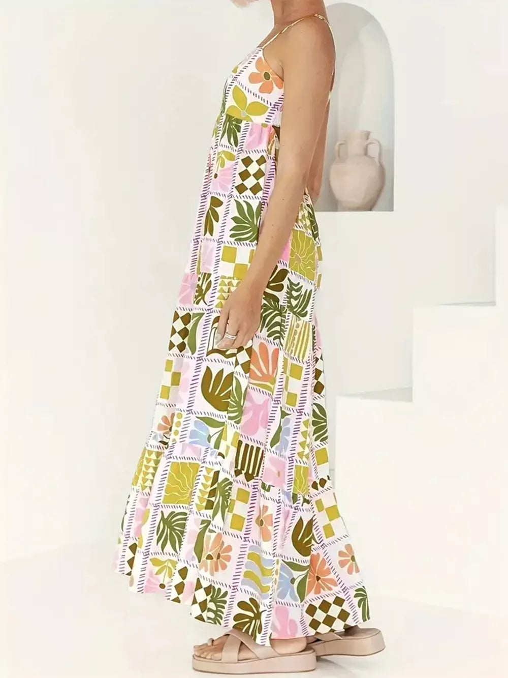 Vibrant cutout back cami maternity swim dress with a colorful abstract floral and leaf print.