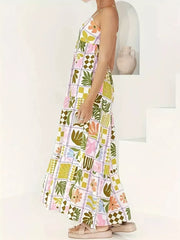 Vibrant cutout back cami maternity swim dress with a colorful abstract floral and leaf print.