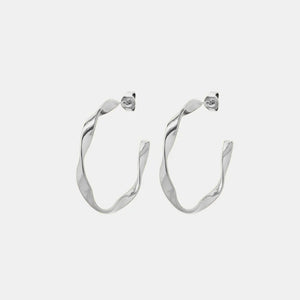 Sculpted silver twist hoop earrings with a modern, chic design.