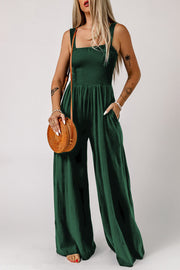 Green smocked square neck wide leg jumpsuit with pockets.