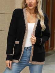 Black knit cardigan with contrast trim and gold buttons, featuring patch pockets.