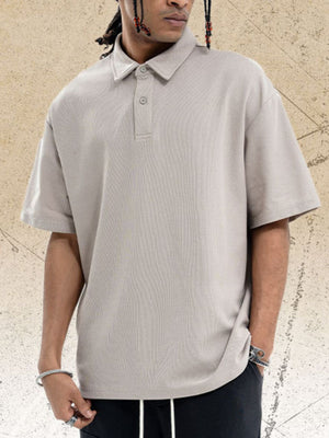 Khaki cotton blend polo shirt with buttoned placket and short sleeves.