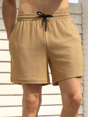 Men's khaki chino shorts with drawstring and textured fabric.
