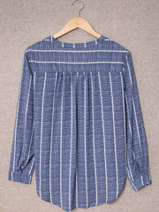 Dusty blue striped V-neck buttoned blouse with long sleeves and a relaxed fit.