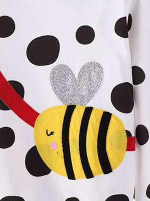 White polka dot sweatshirt with a yellow bee applique and silver heart detail.