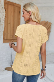 Light yellow perforated eyelet cuffed tee with short sleeves and a relaxed fit.