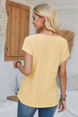 Light yellow perforated eyelet cuffed tee with short sleeves and a relaxed fit.
