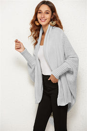 Light gray cocoon knit cardigan with shawl collar and batwing sleeves.