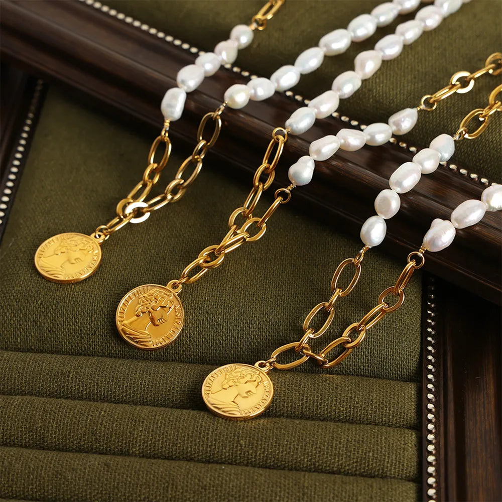 Gold pearl and coin link necklace with oval pearls and gold coin pendant.