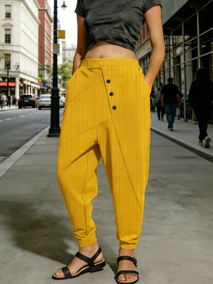 Gold harem pants with decorative buttons and pockets, cuffed ankles.