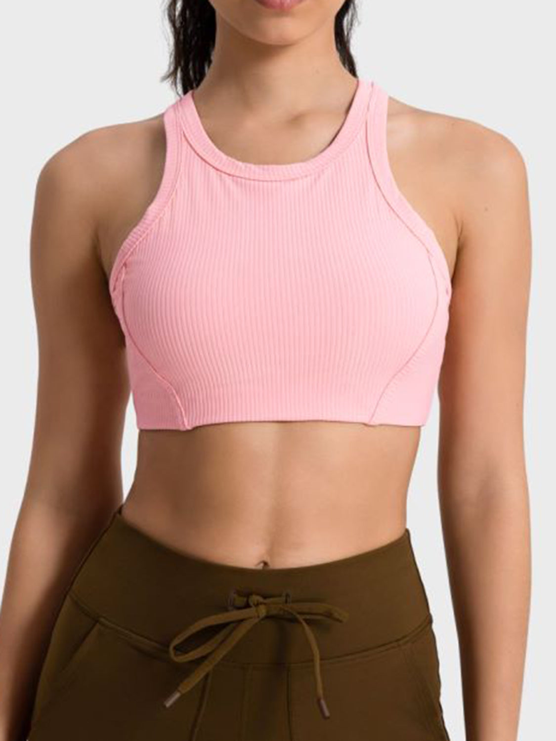 Ribbed blush pink racerback crop top with contour stitching and a high neckline.