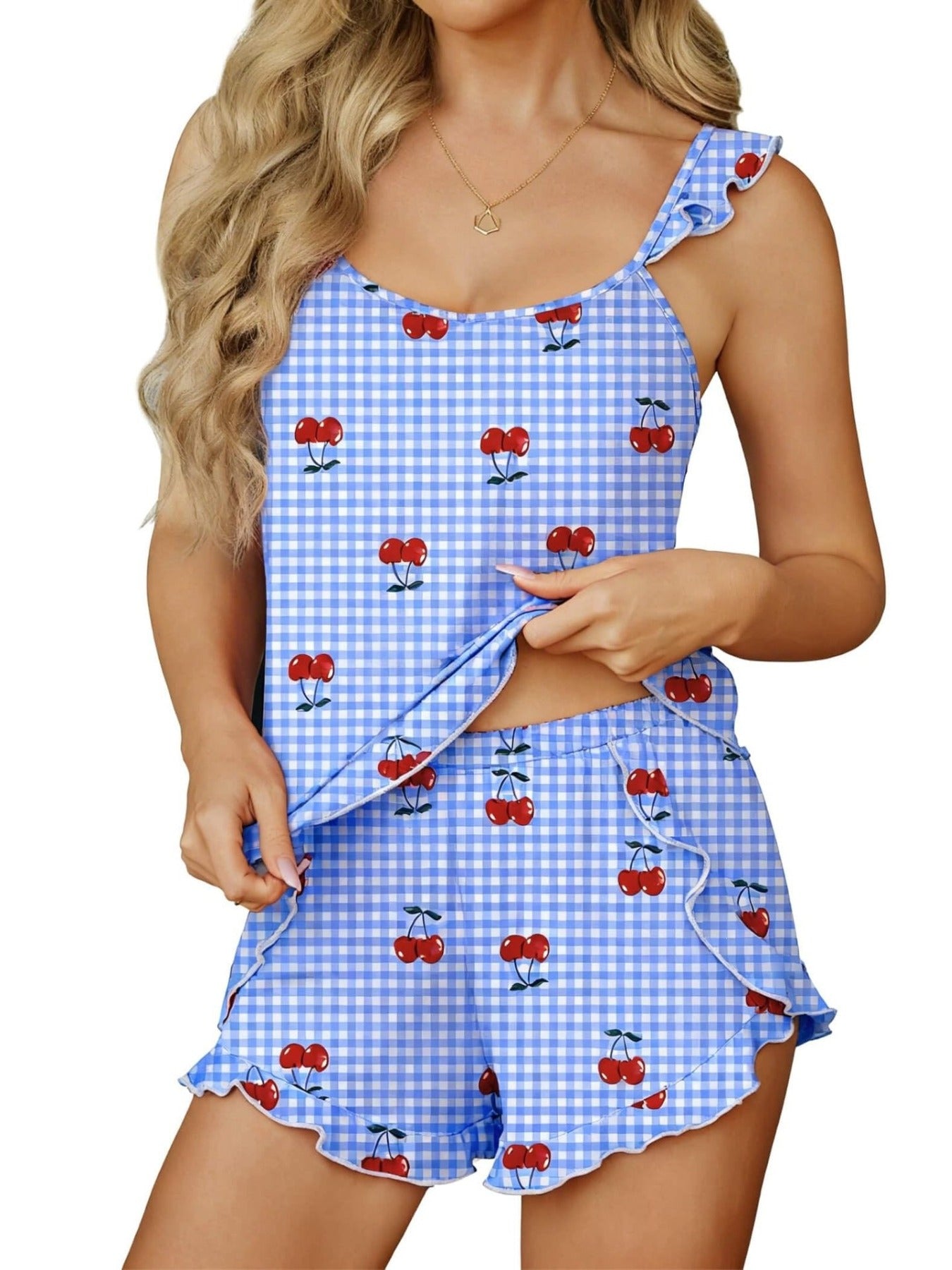 Ruffled cami and shorts set in light blue gingham with cherry print, featuring ruffled trim.