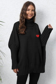 Black batwing knit turtleneck sweater with red heart embroidery and ribbed sleeves.