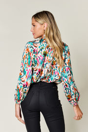 Silk ikat tie-neck blouse with abstract print and balloon sleeves.