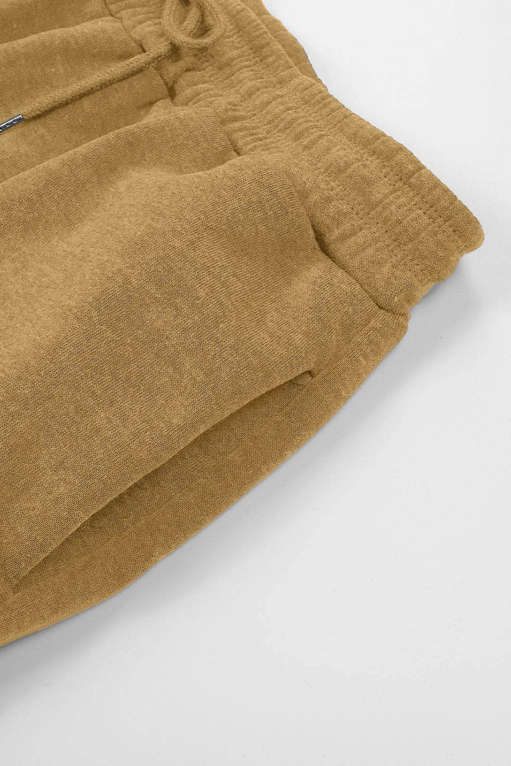 Slouchy sweatpants in tan with gathered cuffs and drawstring detail.