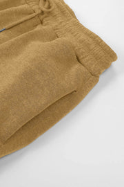 Slouchy sweatpants in tan with gathered cuffs and drawstring detail.
