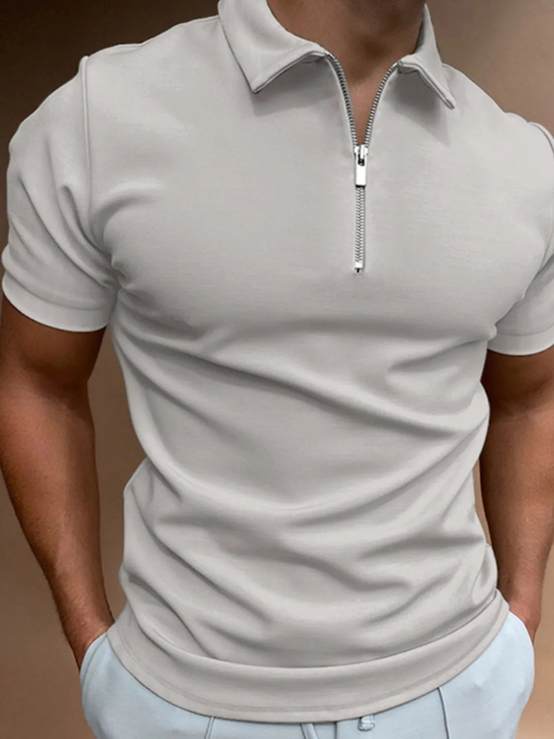 Gray zip-front polo shirt with short sleeves and a streamlined fit.
