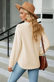 Textured V-neck blouse in Tan with long sleeves and embroidered cuffs.