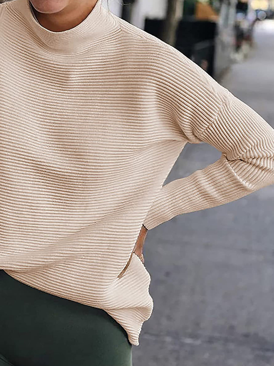 Sand ribbed turtleneck knit sweater with long sleeves and a relaxed fit.