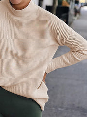Sand ribbed turtleneck knit sweater with long sleeves and a relaxed fit.