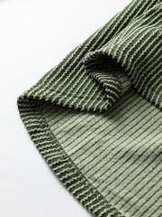 Dark green waffle knit henley top with textured stripe detail and lace sleeves.
