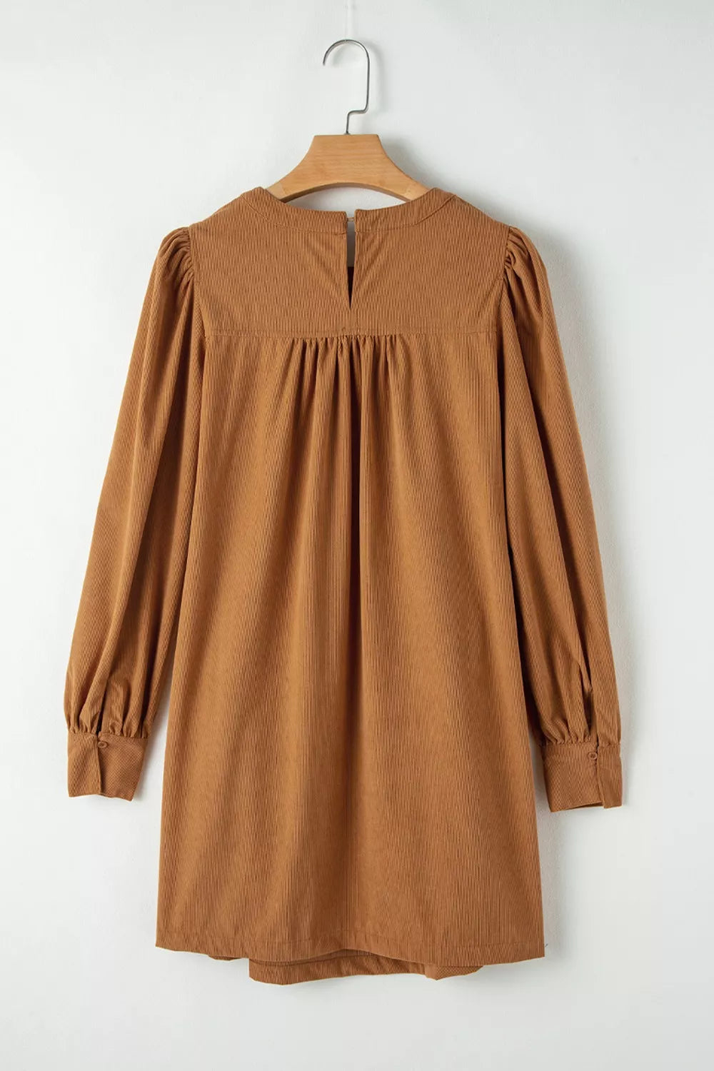 Caramel corduroy mini dress with puff sleeves, buttoned cuffs, and gathered neckline detail.