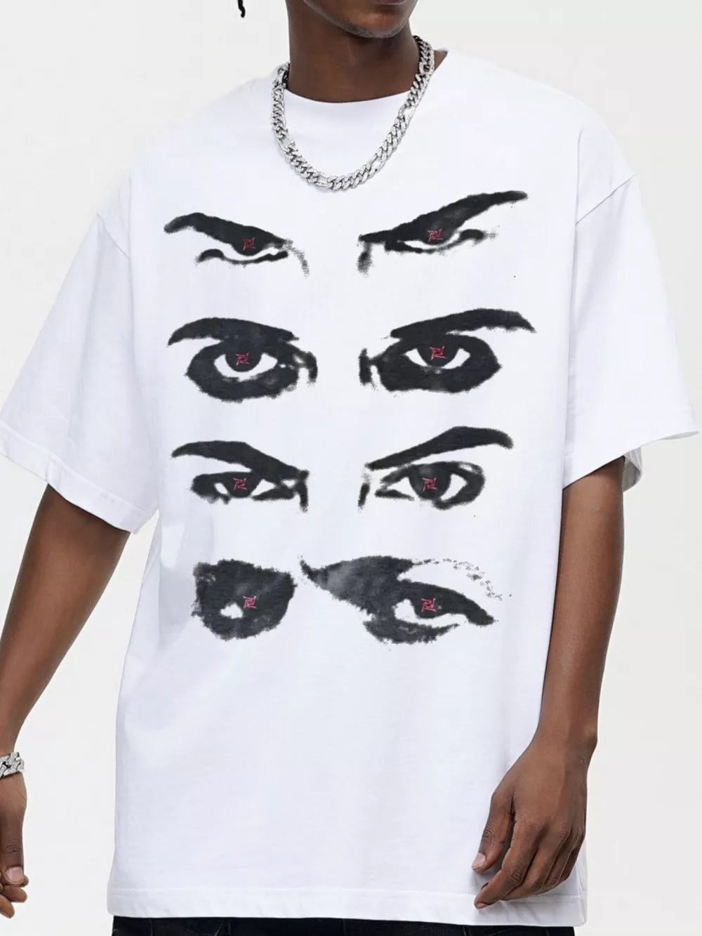 White cotton t-shirt with a bold black eye graphic and red accents.