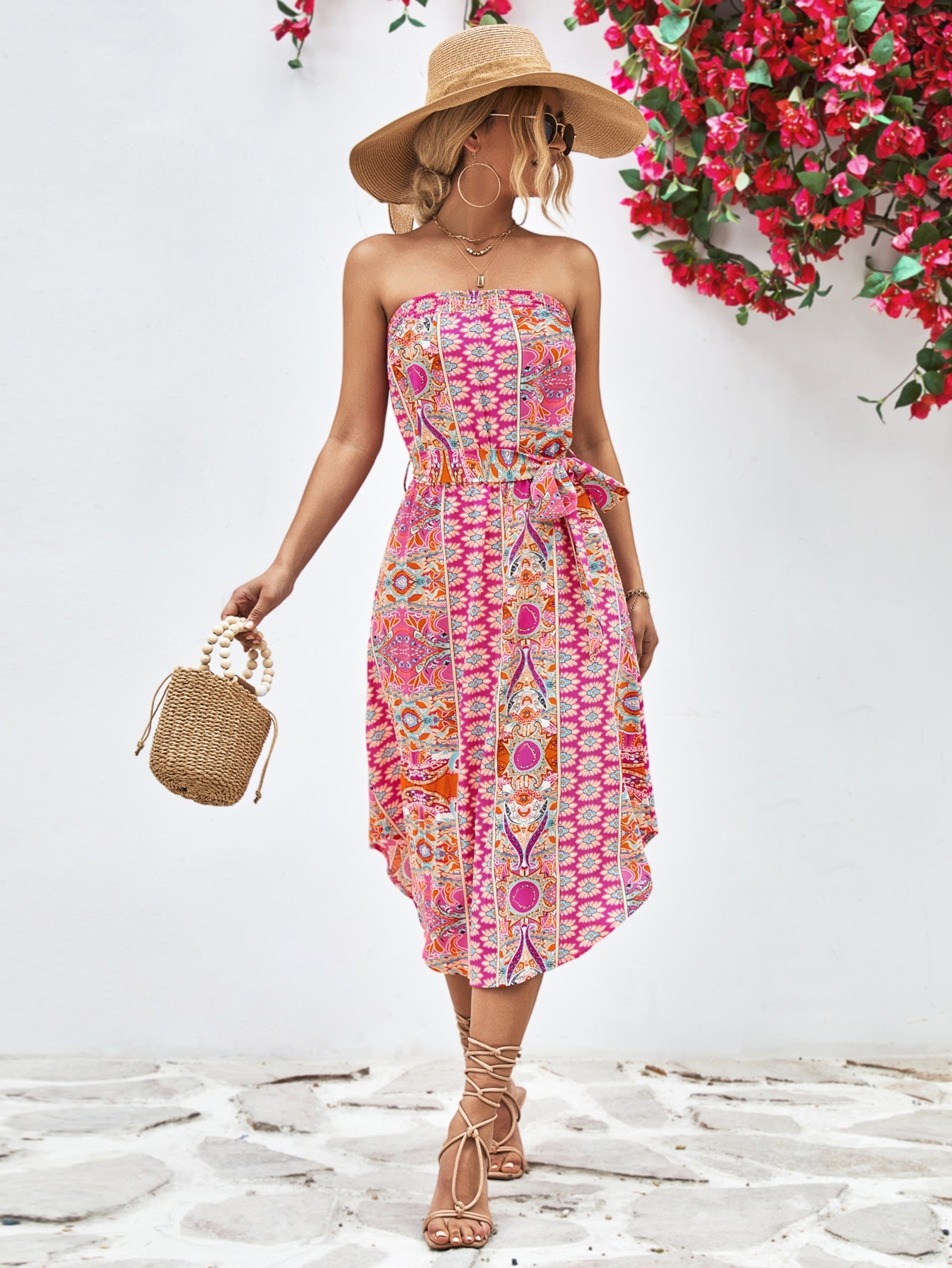 Printed bandeau midi dress with asymmetric hem and belt in pink.