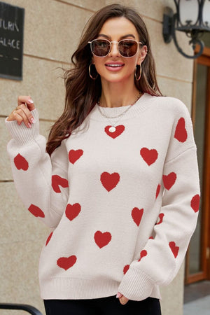 Heartbeat Jacquard Balloon Sleeve Knit sweater in beige with red hearts, crewneck, and ribbed cuffs.